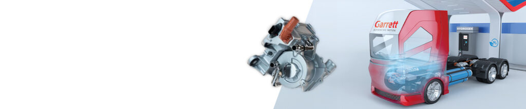 Garrett Air Compressor for Fuel Cell Vehicles next to a fuel cell truck